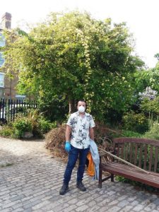 Photo of gardener wearing protective face mask and gloves