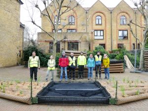 Photo of volunteers posing behing a completed swan nesting raft